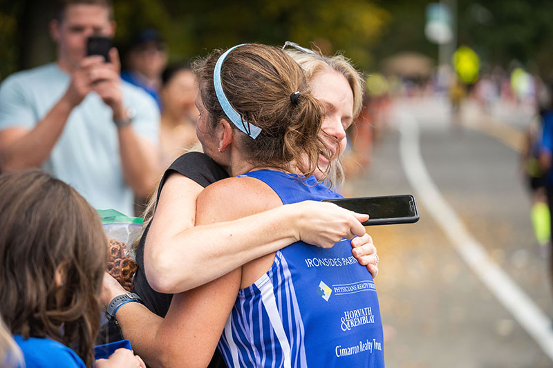 Member of Team Eye and Ear hugging a friends at Boston Marathon