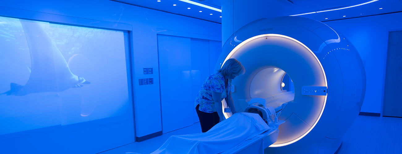 radiology technician sets up an MRI for a patient